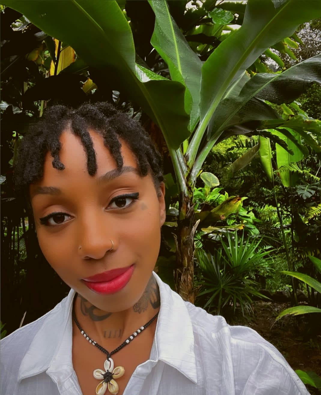 Asani Christie in a tropical garden